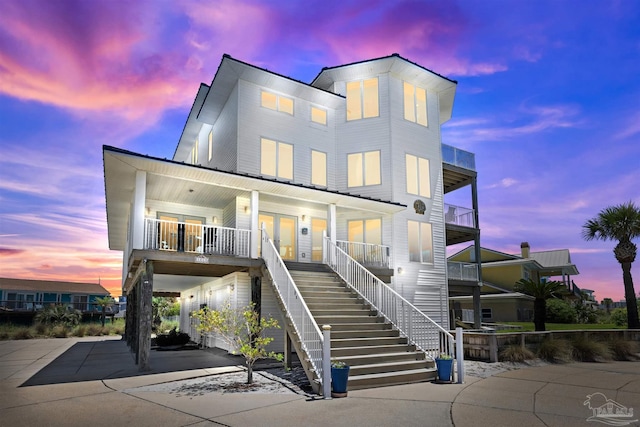 view of front of home featuring stairs and a porch