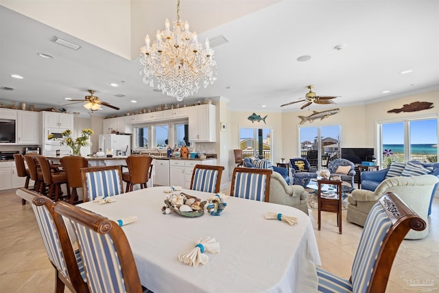 dining area with ceiling fan with notable chandelier and ornamental molding