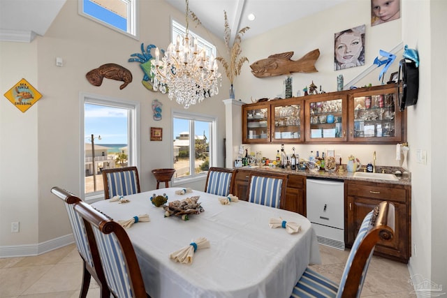 tiled dining room featuring lofted ceiling and a chandelier