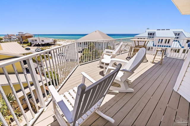 wooden terrace with a water view and a beach view