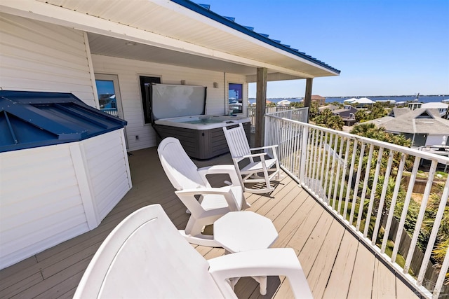 wooden deck featuring a hot tub