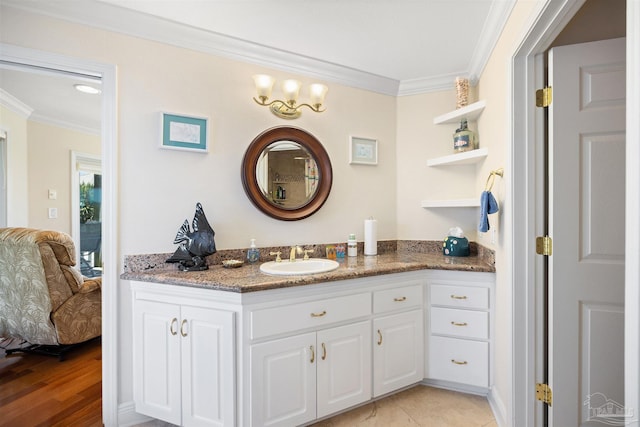 bathroom with hardwood / wood-style flooring, vanity, and ornamental molding