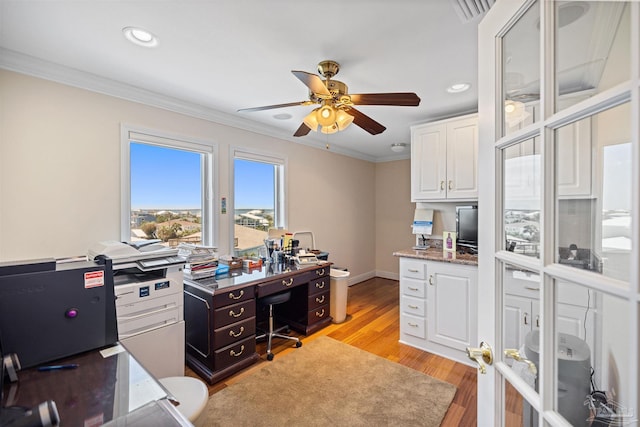 home office featuring ceiling fan, ornamental molding, and light hardwood / wood-style flooring