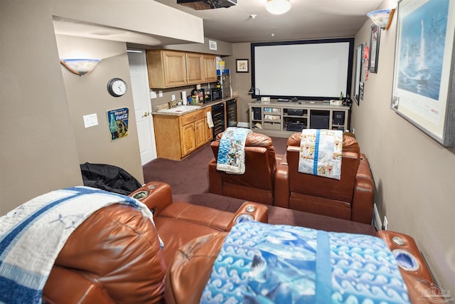 home theater room featuring sink, beverage cooler, and dark colored carpet