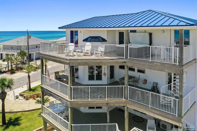 back of property with a water view