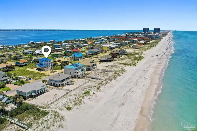 drone / aerial view featuring a water view and a beach view