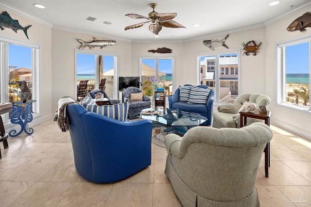 living room featuring crown molding, ceiling fan, and a healthy amount of sunlight