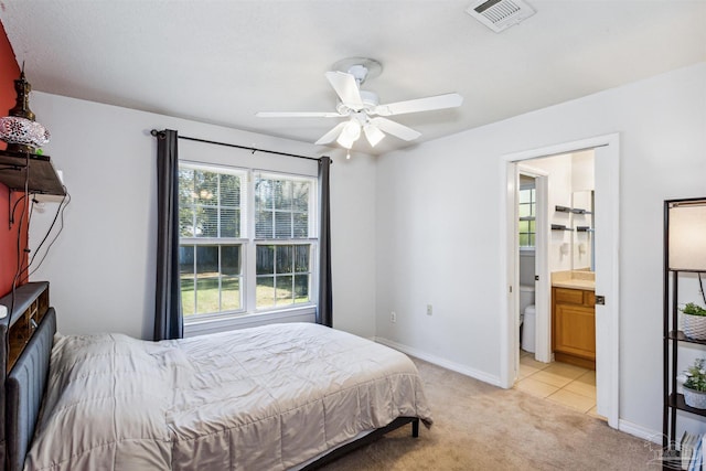 carpeted bedroom with connected bathroom and ceiling fan