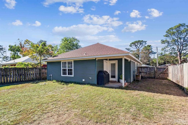 back of house with a yard