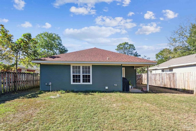 back of property featuring a lawn