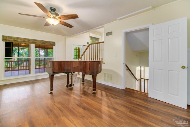 misc room with hardwood / wood-style floors, ornamental molding, and ceiling fan