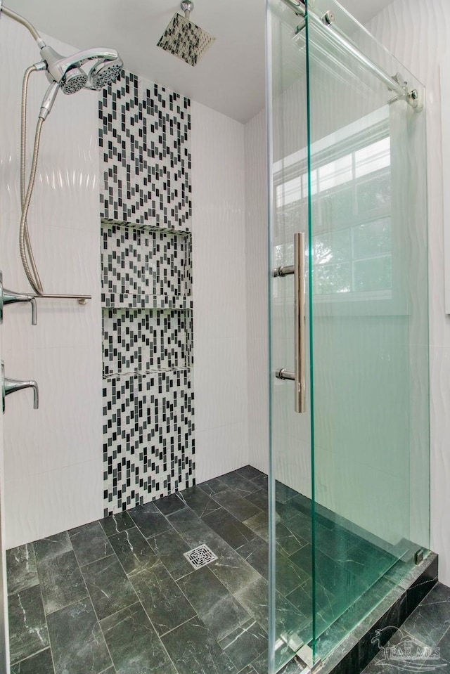 bathroom with a shower with shower door