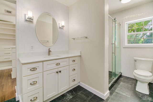 bathroom featuring walk in shower, vanity, and toilet