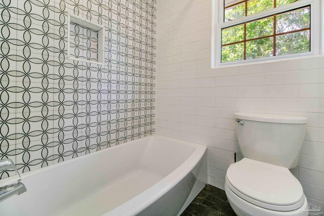 bathroom with tile walls and toilet