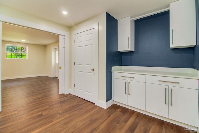 kitchen with white cabinetry and dark hardwood / wood-style flooring