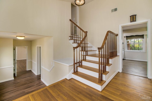 stairs featuring hardwood / wood-style flooring