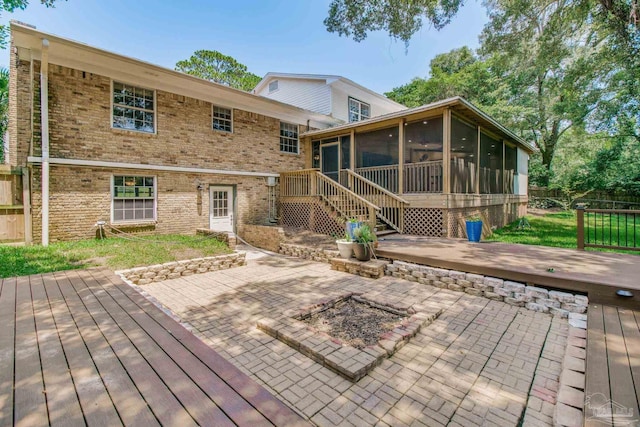 back of house with a patio area, a sunroom, and a deck