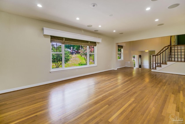 unfurnished living room featuring hardwood / wood-style flooring