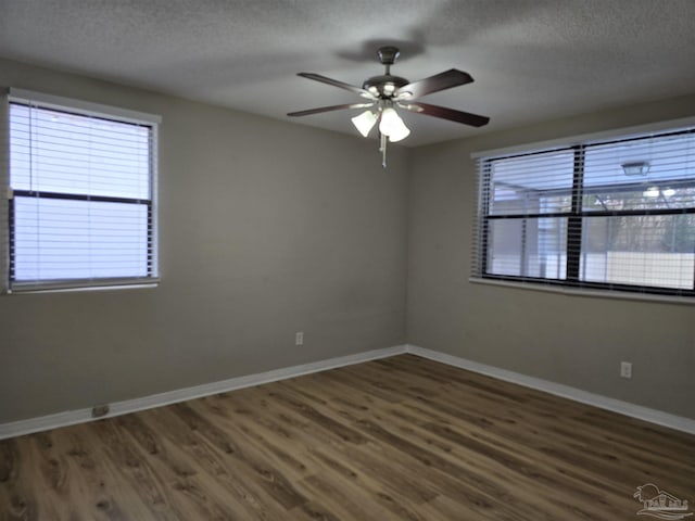 empty room with a ceiling fan, a textured ceiling, baseboards, and wood finished floors