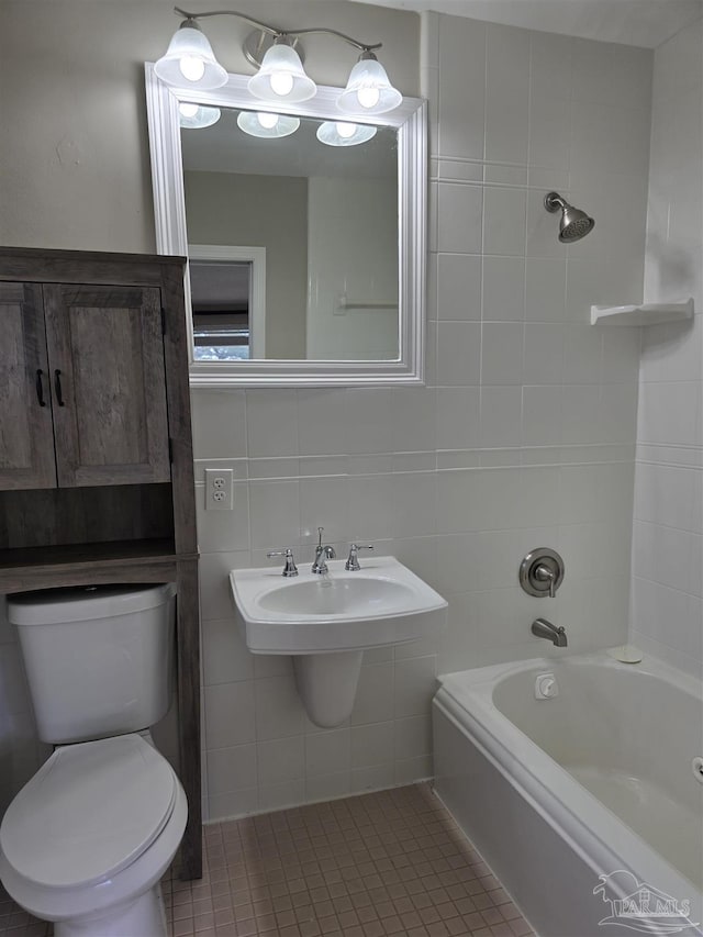 full bath featuring tile walls, decorative backsplash, toilet, shower / tub combination, and tile patterned flooring