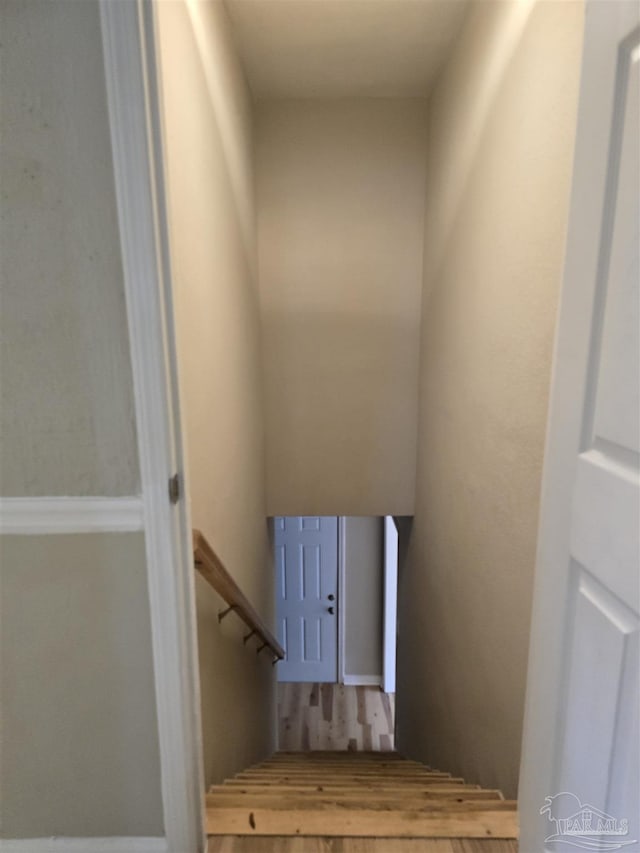 stairway featuring wood finished floors