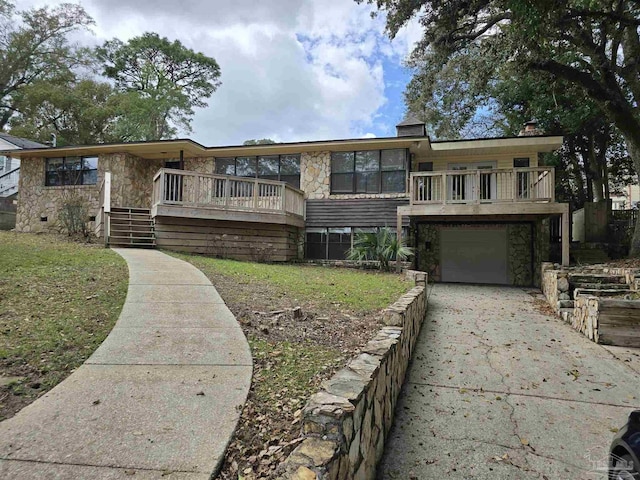 view of front facade with a garage, stone siding, stairway, and concrete driveway