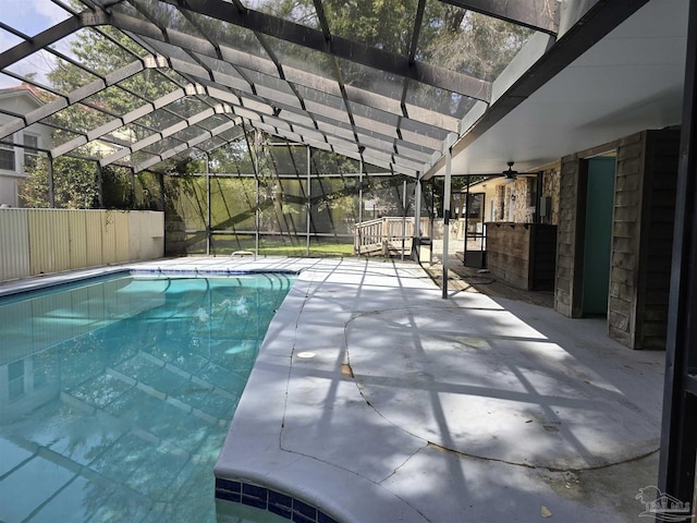 view of pool featuring a fenced in pool, glass enclosure, a patio, and ceiling fan