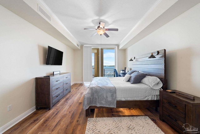 bedroom with dark wood-type flooring, ceiling fan, and access to outside