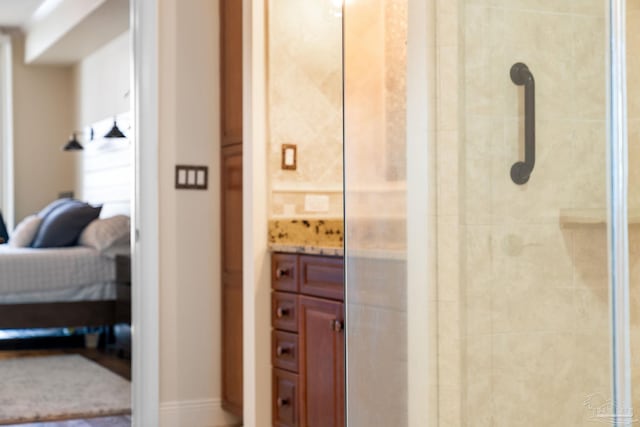 bathroom with vanity and a shower with shower door