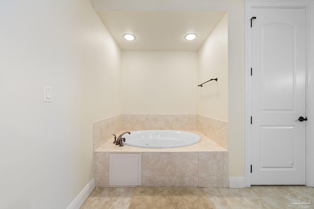 bathroom with tile patterned floors and tiled bath