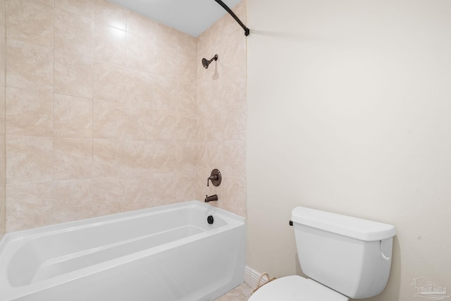 bathroom with tiled shower / bath combo and toilet