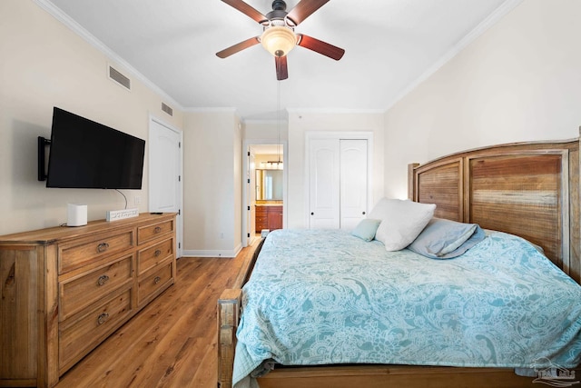 bedroom with ornamental molding, ensuite bathroom, ceiling fan, and light wood-type flooring