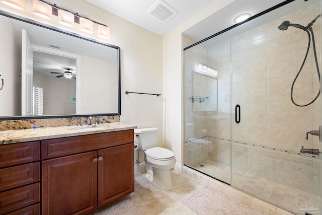 bathroom featuring vanity, toilet, and a shower with door