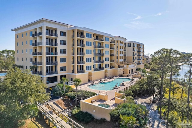 view of building exterior featuring a community pool