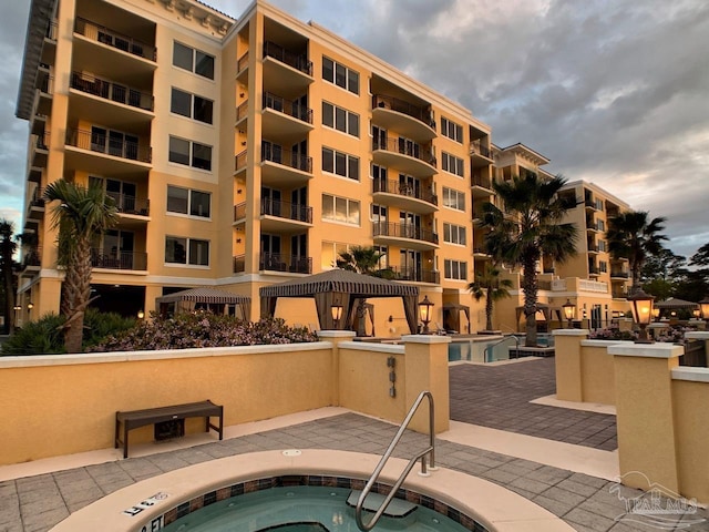 view of swimming pool featuring a hot tub