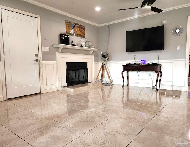 living room with ornamental molding and ceiling fan