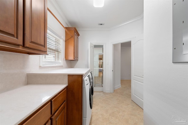 kitchen with ornamental molding, electric panel, and washer and clothes dryer