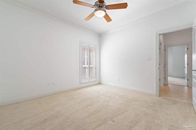 spare room with ornamental molding, light colored carpet, and ceiling fan