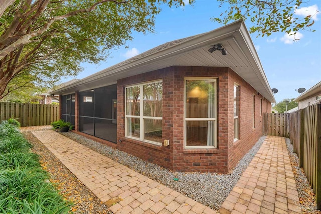 view of side of home with a sunroom