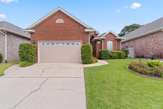 view of property with a front lawn and a garage