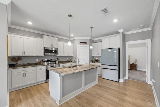1223 Fenwick Ct, Cantonment, FL 32533 - kitchen featuring stainless steel appliances, white cabinets, light wood-style floors, recessed lighting, and dark stone counters