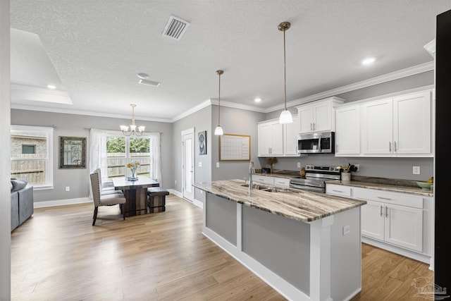 1223 Fenwick Ct, Cantonment, FL 32533 - kitchen with appliances with stainless steel finishes, a chandelier, recessed lighting, light wood-style flooring, and white cabinets