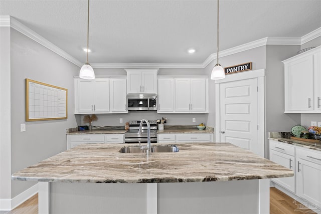 1223 Fenwick Ct, Cantonment, FL 32533 - kitchen with appliances with stainless steel finishes, recessed lighting, crown molding, white cabinetry, and light stone counters