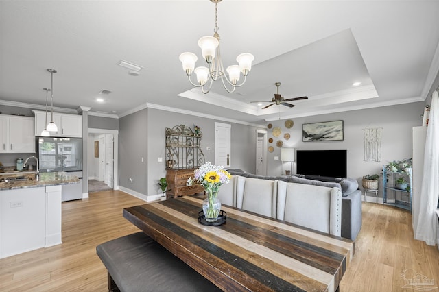 1223 Fenwick Ct, Cantonment, FL 32533 - dining space featuring a ceiling fan, a raised ceiling, ornamental molding, light wood-type flooring, and a chandelier