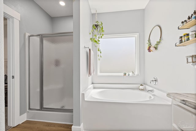 1223 Fenwick Ct, Cantonment, FL 32533 - full bathroom with a shower stall, a garden tub, and wood finished floors