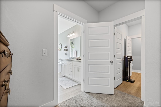1223 Fenwick Ct, Cantonment, FL 32533 - hallway with light wood-style flooring and baseboards