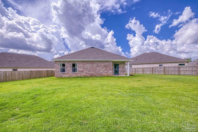 1223 Fenwick Ct, Cantonment, FL 32533 - rear view of house featuring a fenced backyard, brick siding, and a shingled roof