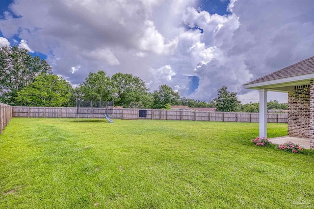 1223 Fenwick Ct, Cantonment, FL 32533 - fenced backyard featuring a trampoline and a patio