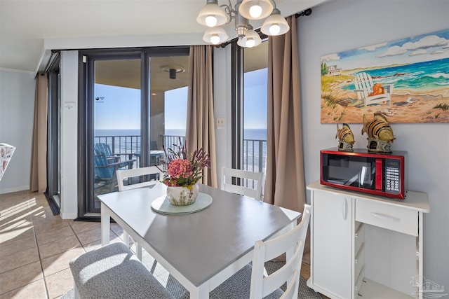 24230 Perdido Beach Blvd Unit 3087, Orange Beach, AL 36561 - dining area featuring a notable chandelier, a water view, and light tile patterned floors
