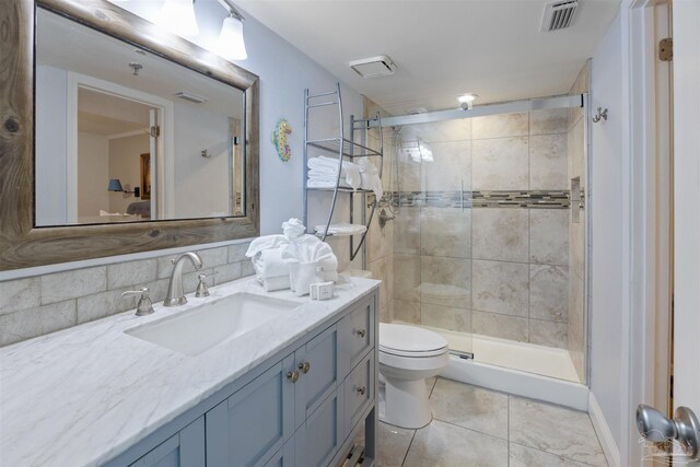 24230 Perdido Beach Blvd Unit 3087, Orange Beach, AL 36561 - bathroom featuring vanity, backsplash, tile patterned flooring, toilet, and an enclosed shower